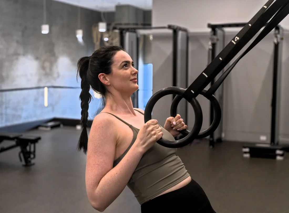 Client training on rings with an Australian Fitness Network personal trainer